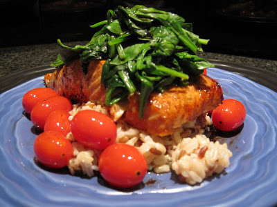 Glazed salmon with spinach and sauteed grape tomatoes