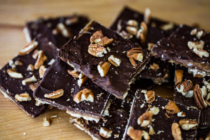 Stacks of Matzo squares covered in toffee, chocolate, pecans, and sea salt makes Matzo Crack