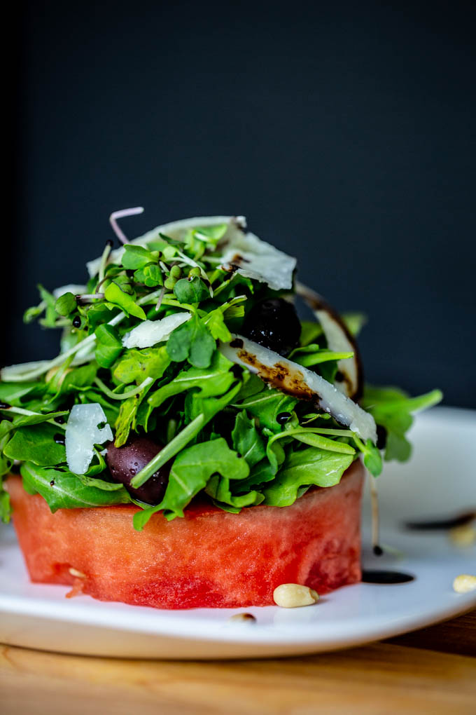 Watermelon Salad with Arugula, Pine Nuts, Peccorino Cheese, Kalamata Olives, & Balsamic Reduction