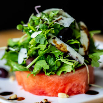 Watermelon Salad with Arugula, Pine Nuts, Peccorino Cheese, Kalamata Olives, & Balsamic Reduction