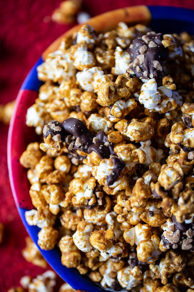 Caramelt Crunch Popcorn - popcorn drenched in a caramel coating drizzled with dark chocolate and crumbled toffee bits