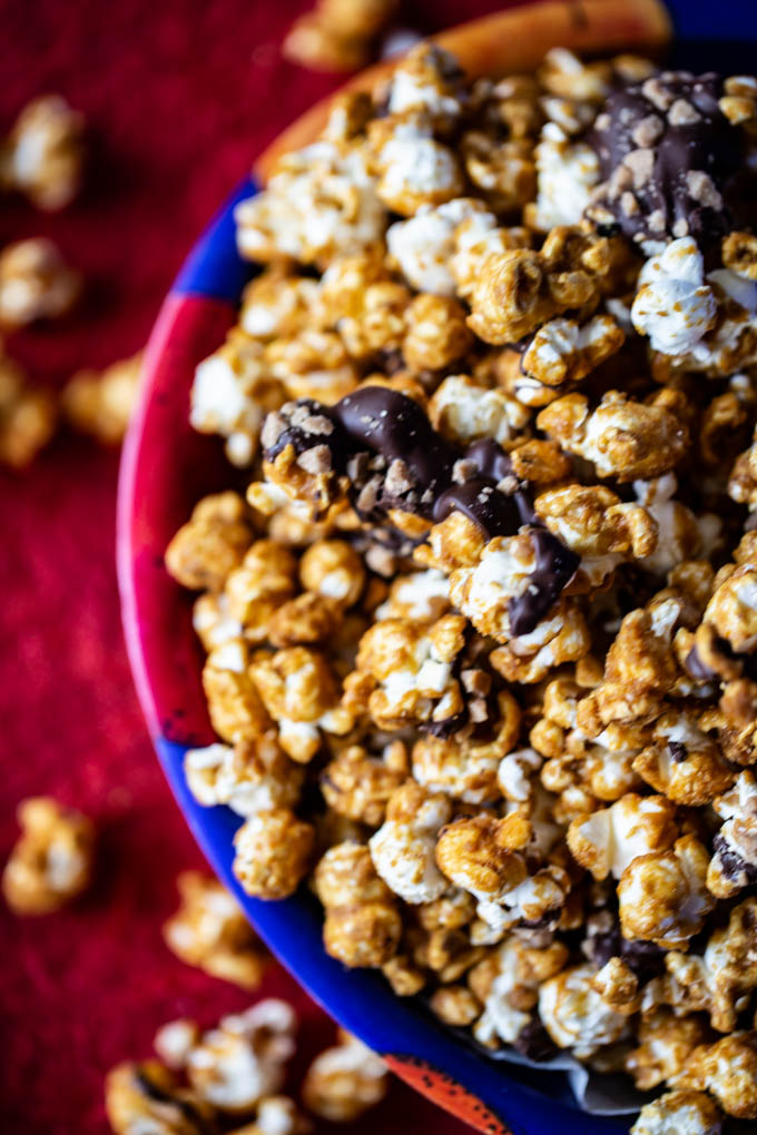 Caramelt Crunch Popcorn - popcorn drenched in a caramel coating drizzled with dark chocolate and crumbled toffee bits