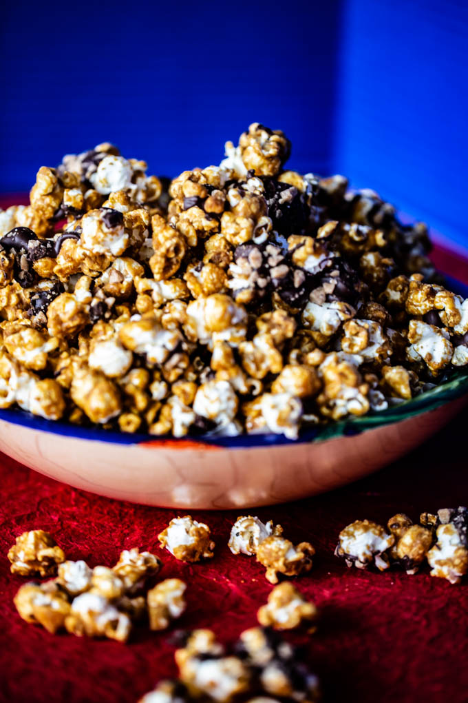 Caramelt Crunch Popcorn - popcorn drenched in a caramel coating drizzled with dark chocolate and crumbled toffee bits