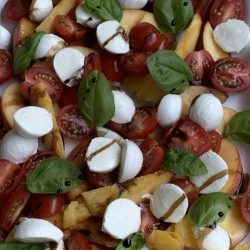 Grilled Peaches with mozzarella balls, tomatoes , basil, and balsamic reduction