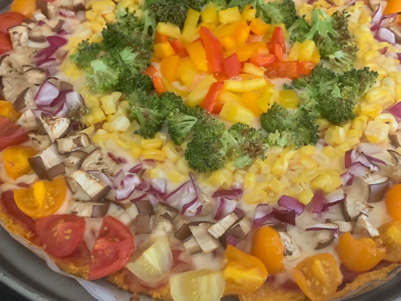Rainbow Pizza with a sweet potato crust, bell peppers, corn, onions, butternut squash, eggplant, and broccoli