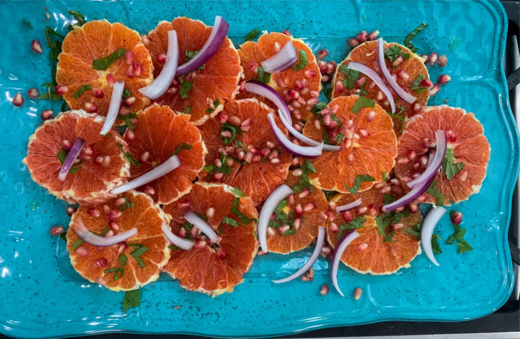 Orange and Pomegranate Salad with warm spices, slivered onions and pomegranate arils with a honey lime vinaigrette