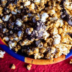 Caramelt Crunch Popcorn is caramel popcorn drizzled with dark chocolate and heath bar bits