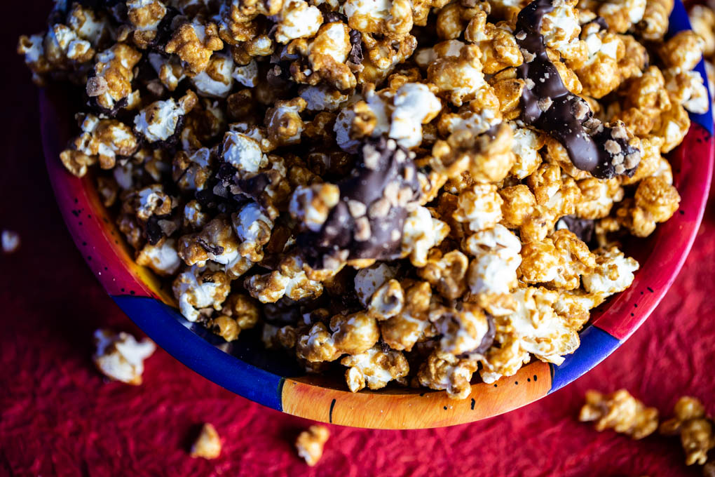 Caramelt Crunch Popcorn is caramel popcorn drizzled with dark chocolate and heath bar bits